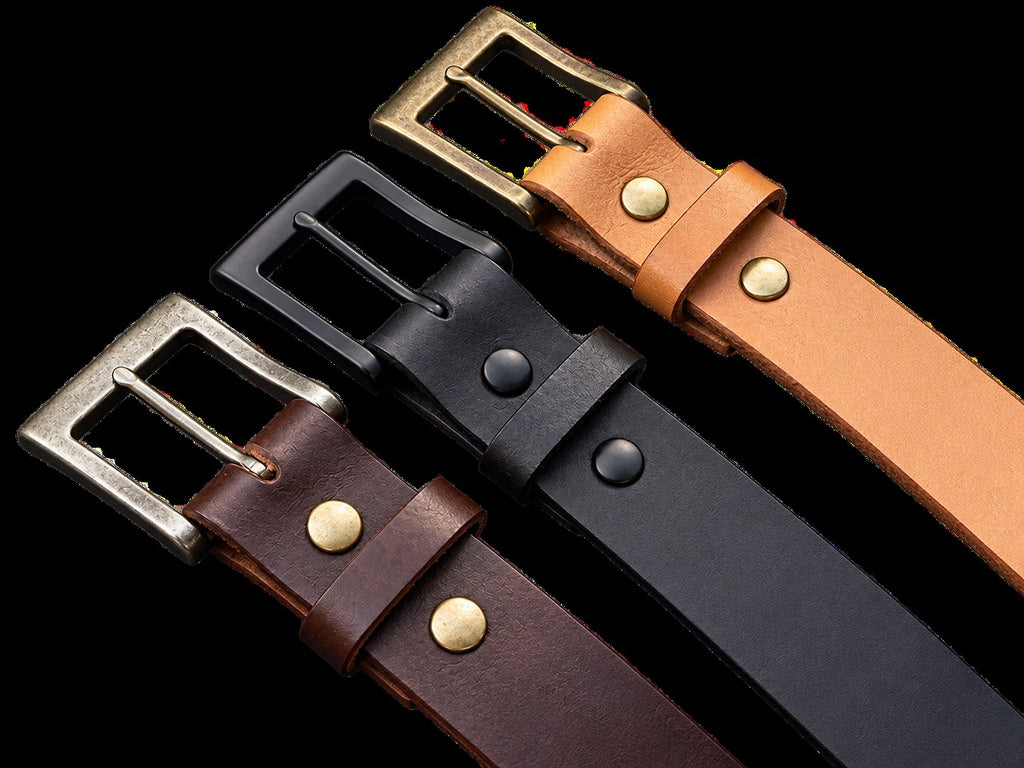 Three English Bridle leather belts with matching buckles on denim